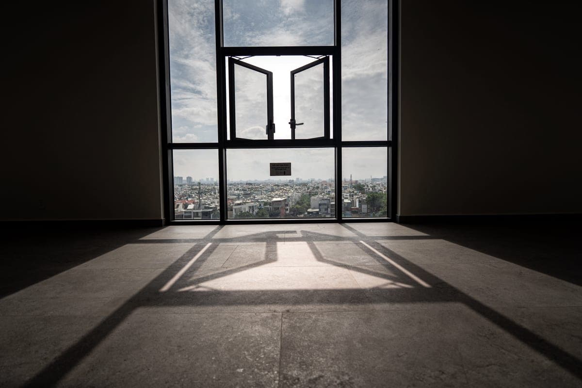 Soft daylight falling across an empty corner of a small apartment room